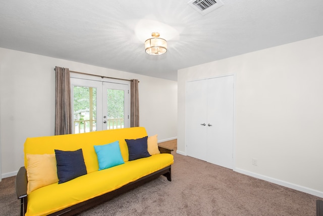 sitting room with carpet floors and french doors