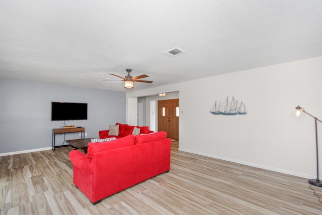 living room with light hardwood / wood-style floors and ceiling fan