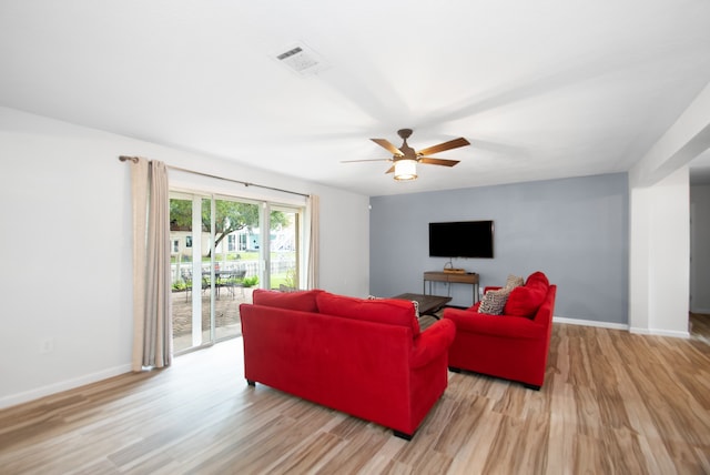 living room featuring light wood-type flooring and ceiling fan