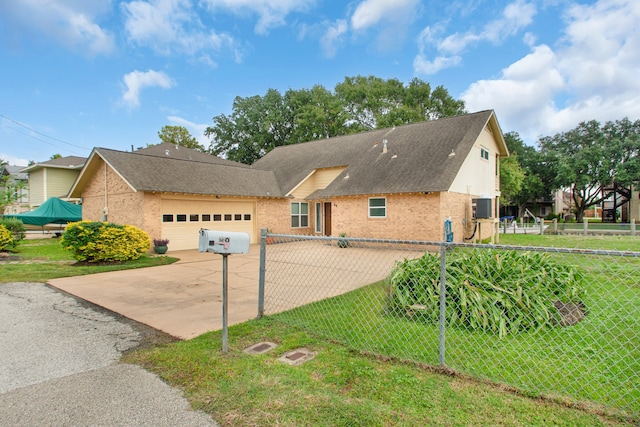 view of front of home with a front lawn and a garage