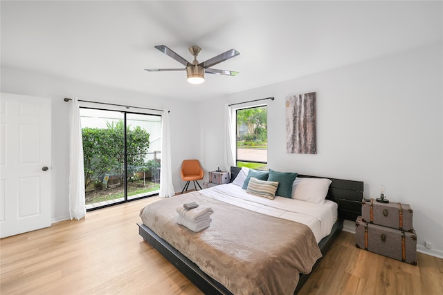 bedroom featuring multiple windows, light wood-type flooring, and ceiling fan