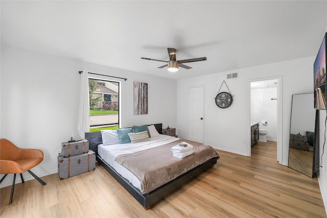 bedroom with ceiling fan, hardwood / wood-style flooring, and ensuite bath