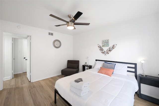 bedroom with light hardwood / wood-style flooring and ceiling fan