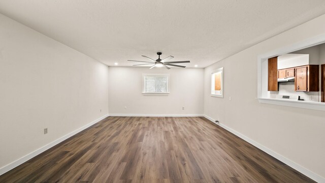 spare room featuring ceiling fan and dark hardwood / wood-style flooring