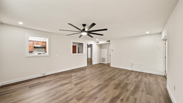 unfurnished room with ceiling fan and wood-type flooring