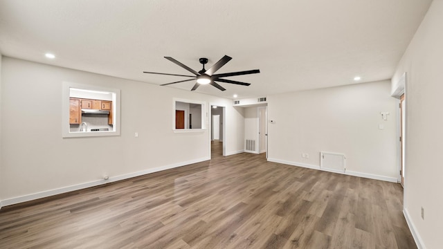 interior space featuring hardwood / wood-style floors and ceiling fan