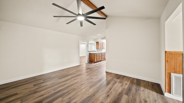 empty room featuring lofted ceiling with beams, hardwood / wood-style floors, and ceiling fan