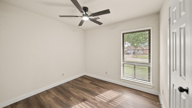 empty room featuring dark hardwood / wood-style flooring and ceiling fan