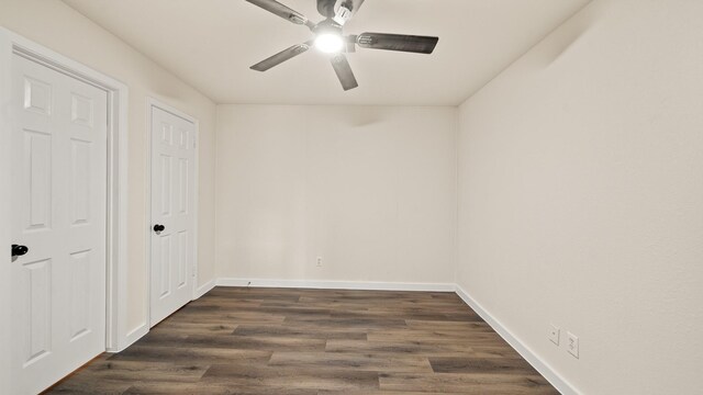 unfurnished bedroom featuring ceiling fan and dark wood-type flooring