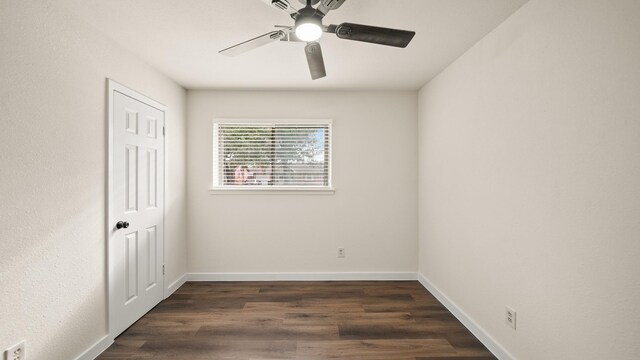 empty room with ceiling fan and dark wood-type flooring