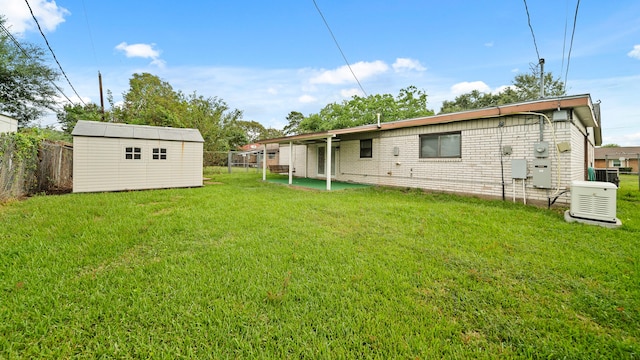 rear view of property featuring a patio, cooling unit, a shed, and a yard