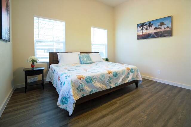 bedroom with dark hardwood / wood-style flooring