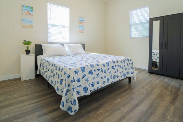 bedroom with dark wood-type flooring