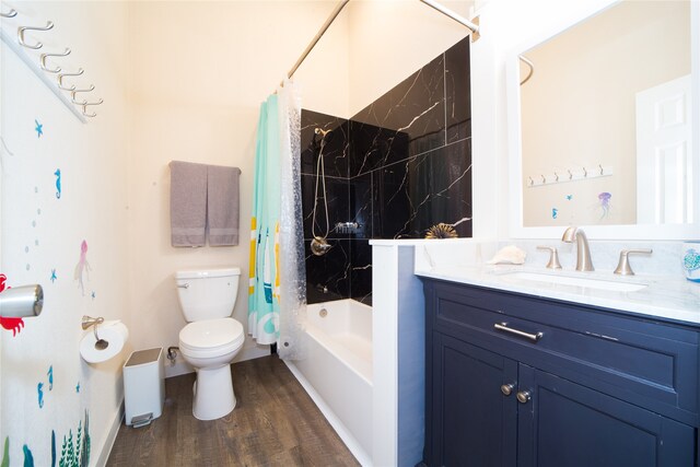 full bathroom with wood-type flooring, vanity, shower / bath combo with shower curtain, and toilet