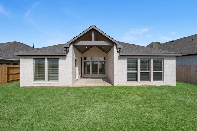 rear view of house with a yard