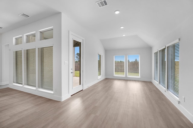 interior space with light hardwood / wood-style flooring and lofted ceiling