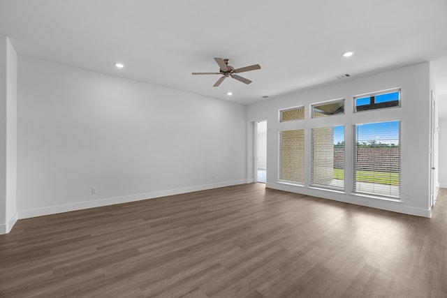 spare room with ceiling fan and dark hardwood / wood-style flooring