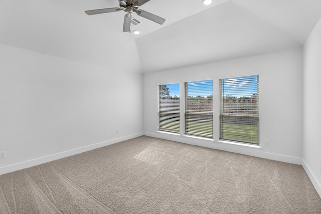 carpeted spare room with high vaulted ceiling and ceiling fan