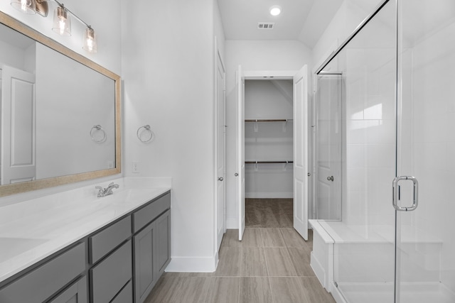 bathroom featuring vanity and a shower with shower door