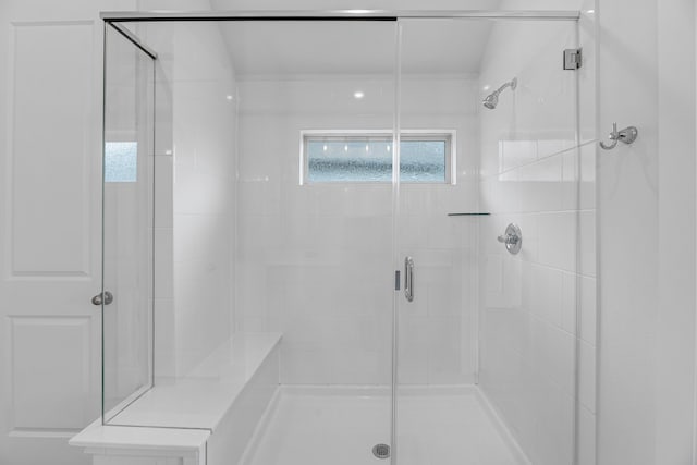 bathroom with a shower with door