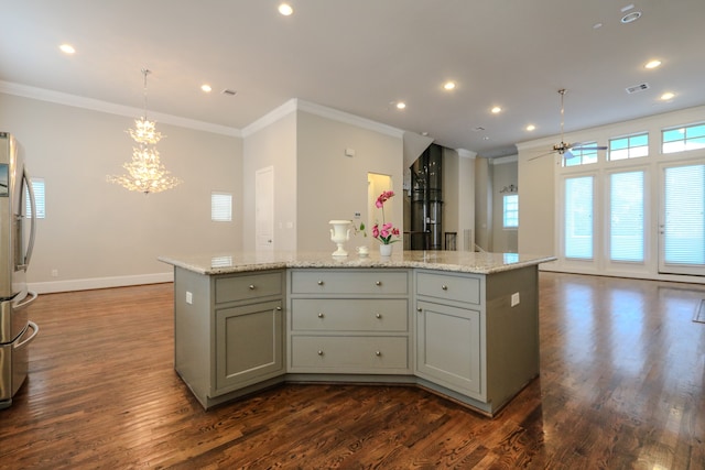 kitchen featuring hanging light fixtures, gray cabinetry, dark hardwood / wood-style floors, a center island, and ceiling fan with notable chandelier