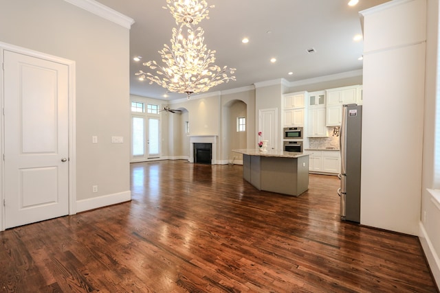 kitchen featuring white cabinetry, a center island, dark hardwood / wood-style floors, and stainless steel refrigerator