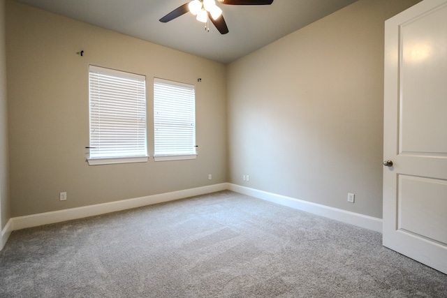 carpeted empty room featuring ceiling fan