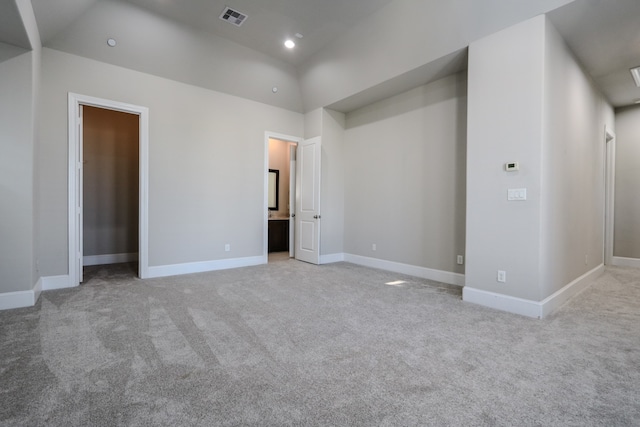 interior space with light carpet and ensuite bath