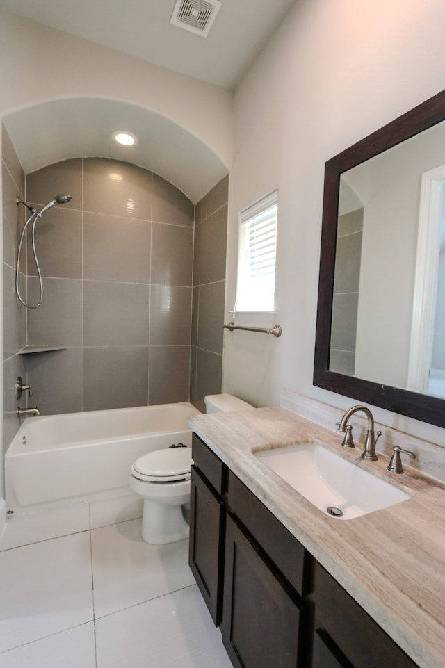 full bathroom featuring vanity, tiled shower / bath combo, toilet, and tile patterned floors