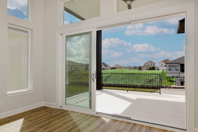 doorway to outside with wood-type flooring