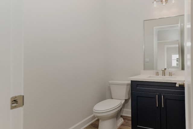 bathroom with vanity, wood-type flooring, and toilet