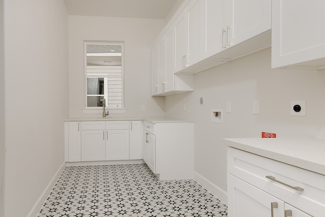 washroom featuring hookup for an electric dryer, hookup for a washing machine, cabinets, and sink