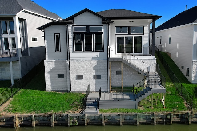 rear view of property with a water view