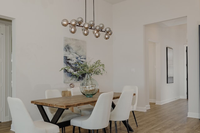 dining room featuring a chandelier and wood-type flooring