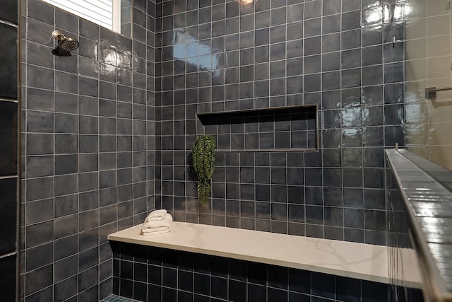 bathroom featuring tile walls and tiled shower