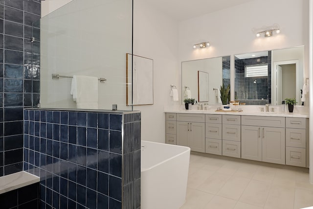 bathroom featuring tile patterned flooring, vanity, tile walls, and plus walk in shower