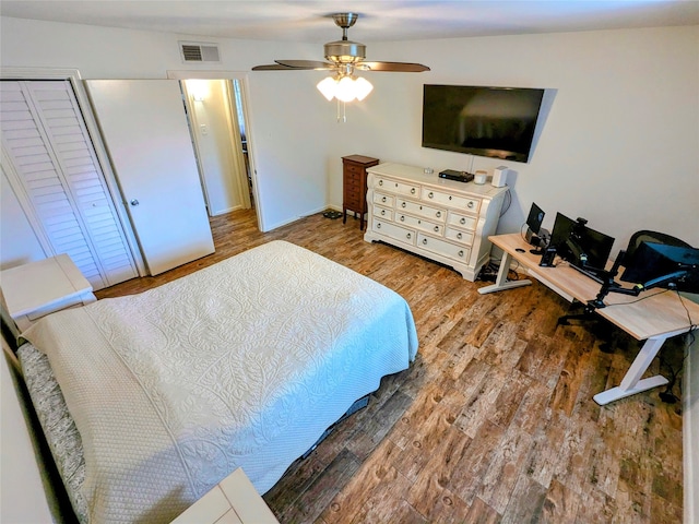 bedroom featuring wood-type flooring, a closet, lofted ceiling, and ceiling fan