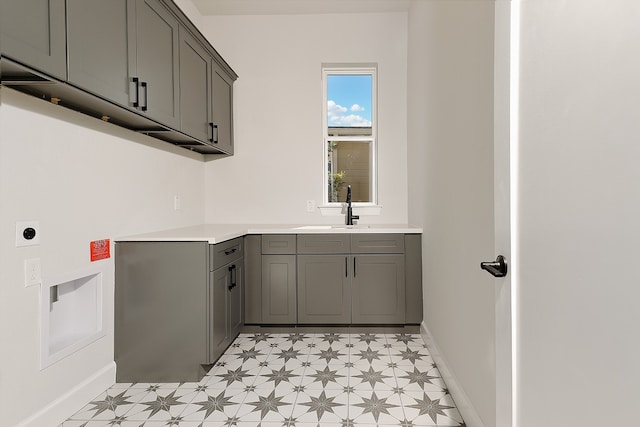 clothes washing area with cabinets, sink, and electric dryer hookup