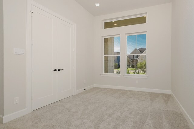 unfurnished bedroom featuring light colored carpet