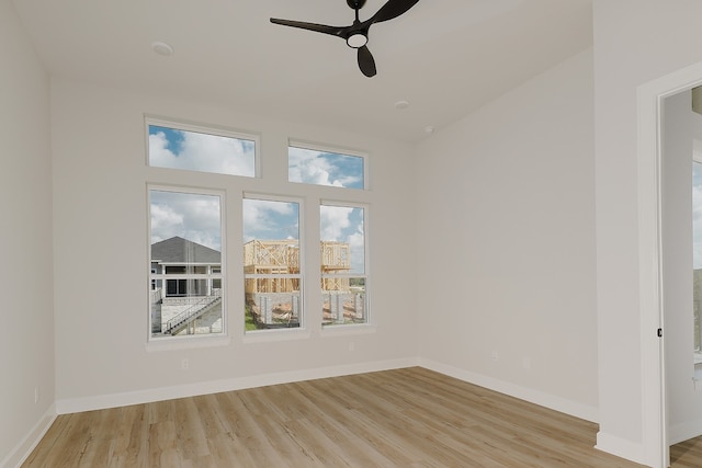 unfurnished room featuring light wood-type flooring and ceiling fan