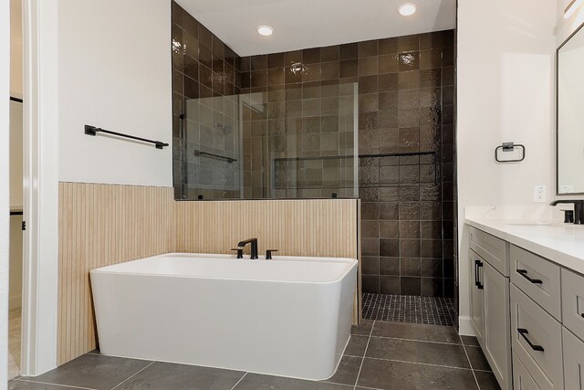 bathroom featuring tile walls, tile patterned flooring, vanity, and independent shower and bath