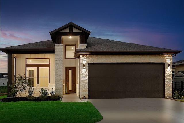 view of front of house with a lawn and a garage