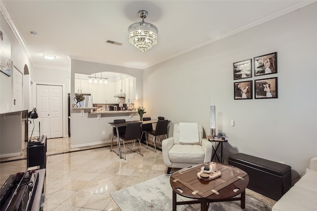 living room featuring a notable chandelier and ornamental molding