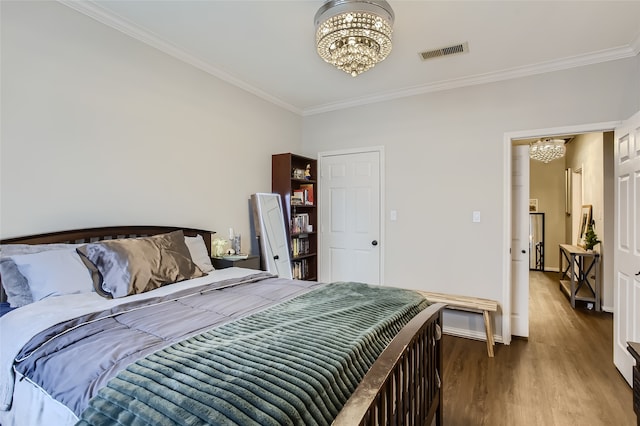 bedroom with ornamental molding, dark wood-type flooring, and a notable chandelier