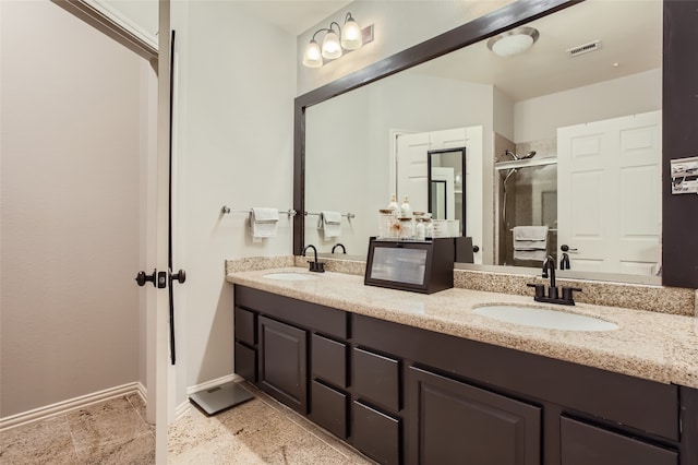 bathroom featuring vanity and a shower with shower door