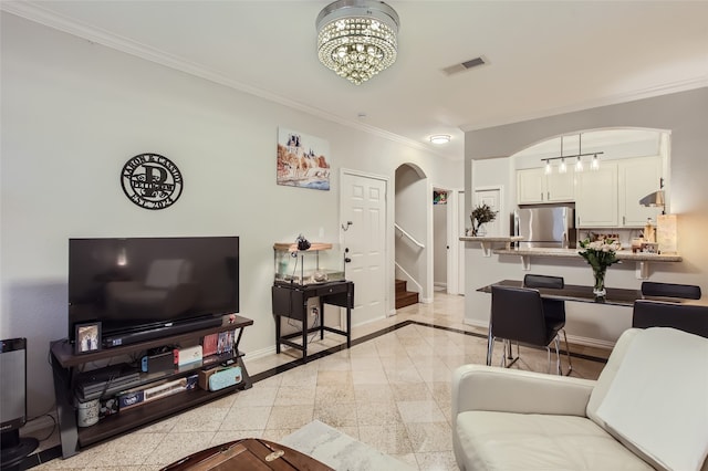 living room with a notable chandelier and crown molding