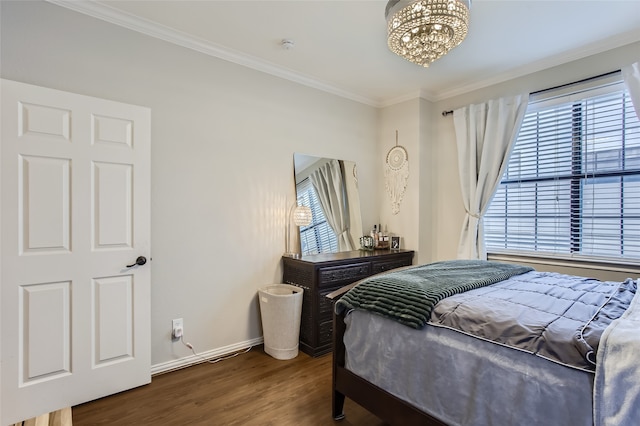 bedroom featuring ornamental molding, dark wood-type flooring, and a chandelier