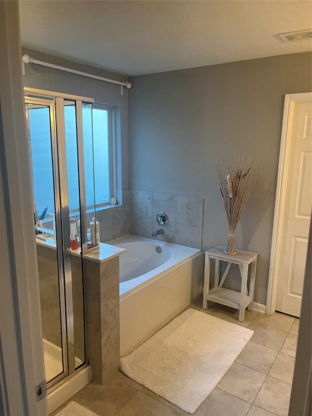 bathroom featuring plus walk in shower and tile patterned floors