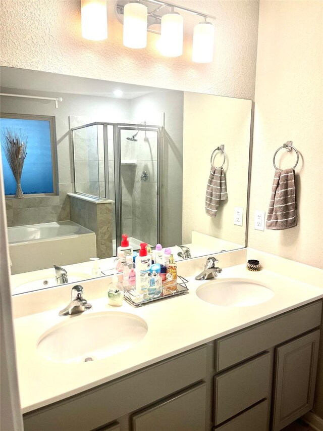 bathroom with independent shower and bath and vanity