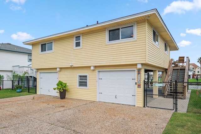 rear view of house featuring a garage